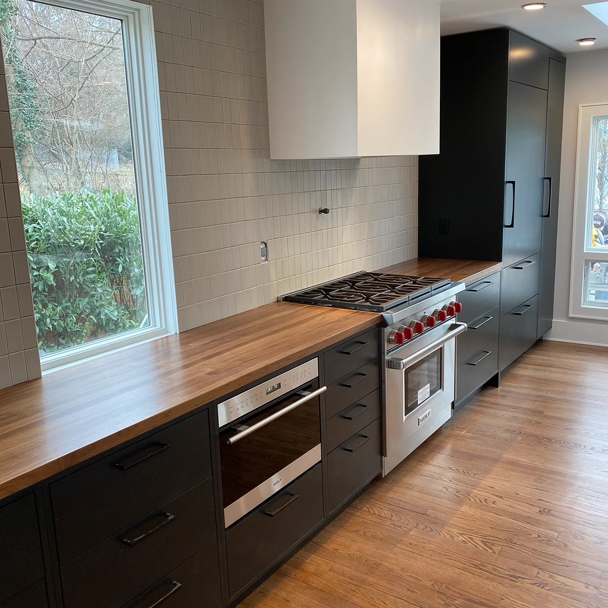 Black kitchen with walnut countertops