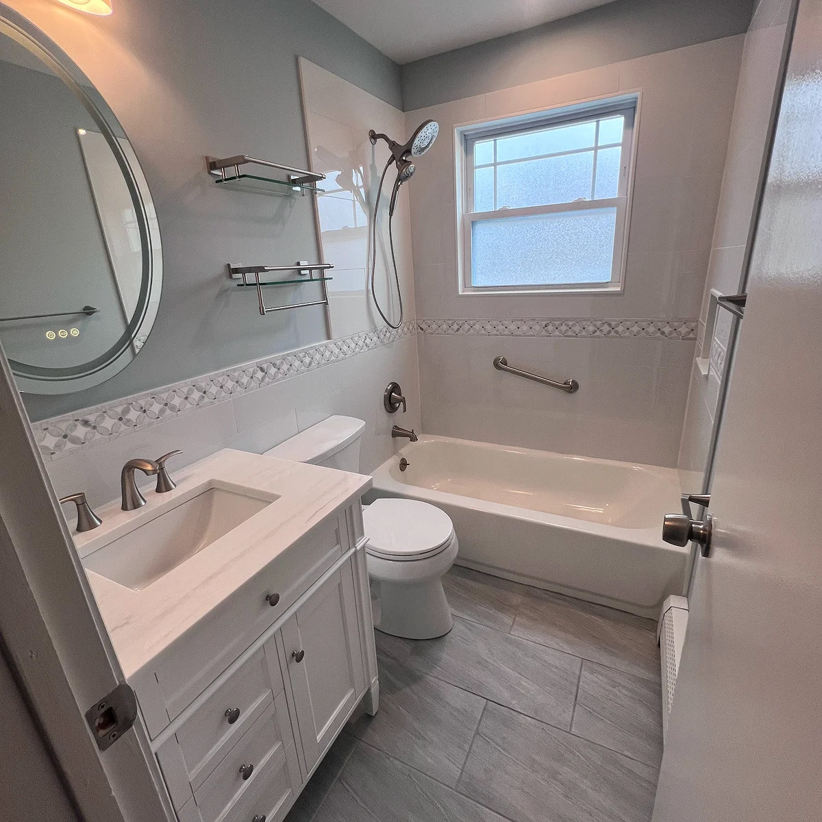 Compact gray and white tub bathroom