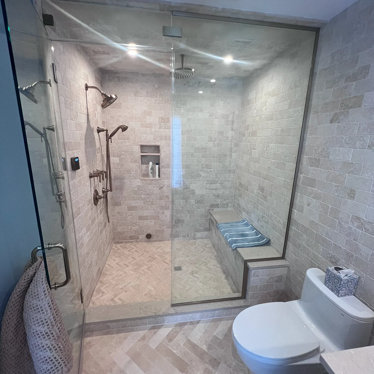 Stone walk-in shower with bench