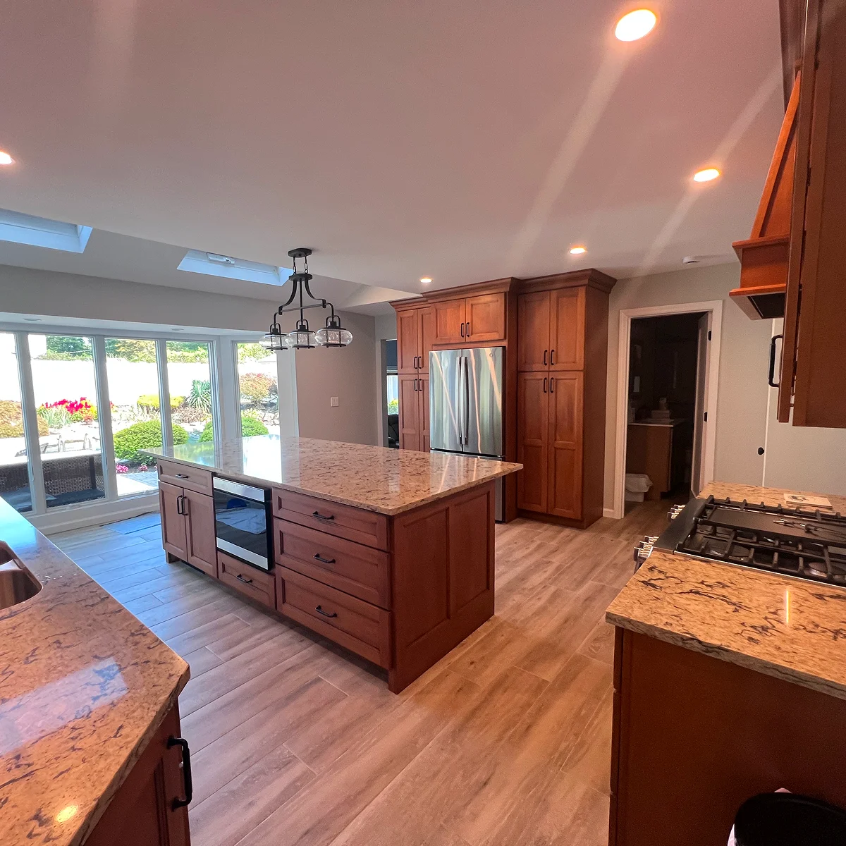 Warm wood kitchen with granite island