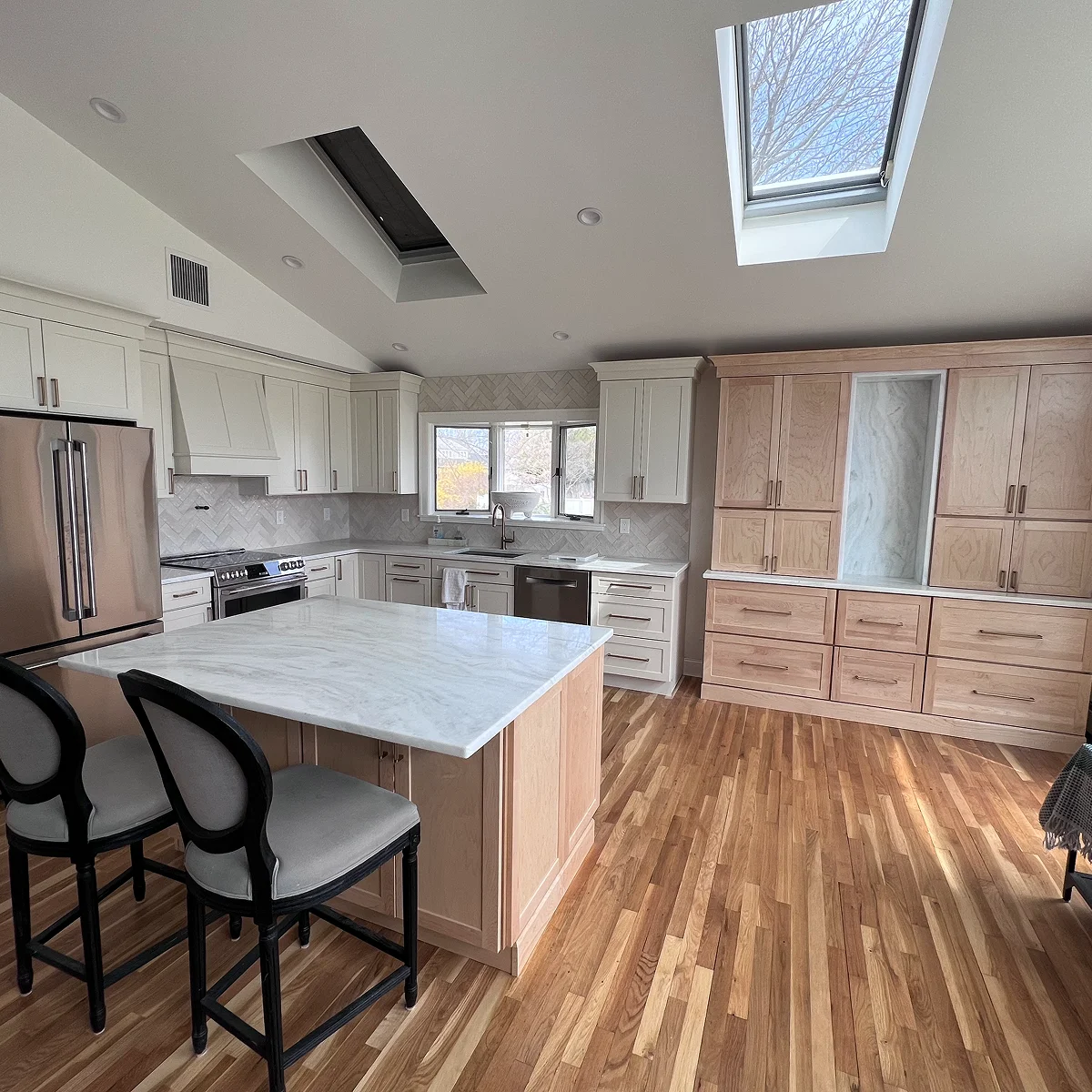 White and natural wood kitchen with skylight
